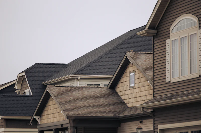 Row of houses with brown shingle roofs and gables