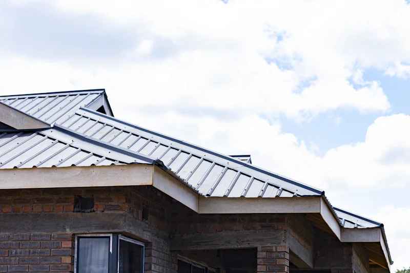 Brick house with a new metal roof and a covered porch